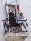 Cuban overlooking passersby, Leonor Perez Street (Paula), Havana
