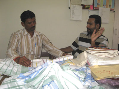 Nagappa (BMKA) discussing tea towels with Mathew from MESH