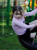 Little girl on a swing