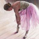 Ballerina tying pointe shoes