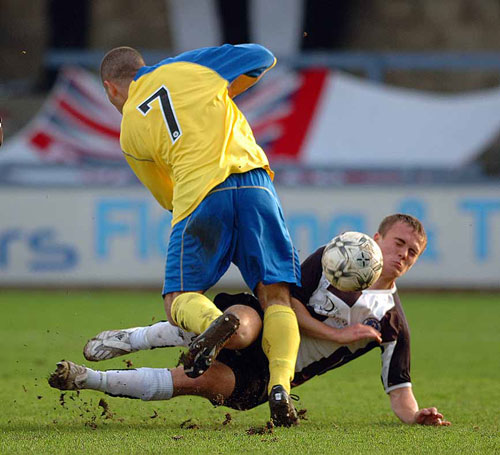 Dorchester's Bradley Middleton feels the force from St Albans Paul Hakim - 26.01.08