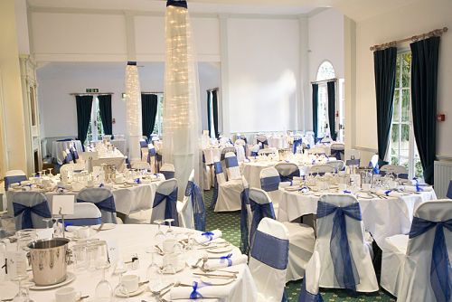 Pillars dressed with fairy lights and organza drapes