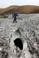 03D-5002 Walker Crossing a Crevasse in a Snow Field on the  Laugavegur Hiking Trail from Landmannalaugar to Thorsmork in the Fjallabak Area of Iceland