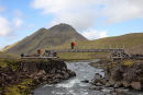 03D-5406 Hikers Crossing a Bridge Over the River Kaldaklofskvisl on the Laugavegur Hiking Trail With the Mountain of Storasula Behind Iceland