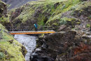 03D-5656 Hiker on the Bridge Crosssing the Canyon of the Syori-Emstrua on the Laugavegurinn Hiking Trail Iceland