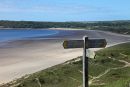 04D-8912 Coastal Footpath Sign to Nicholaston and Three Cliffs Bay With Oxwich Bay Behind Gower South Wales UK