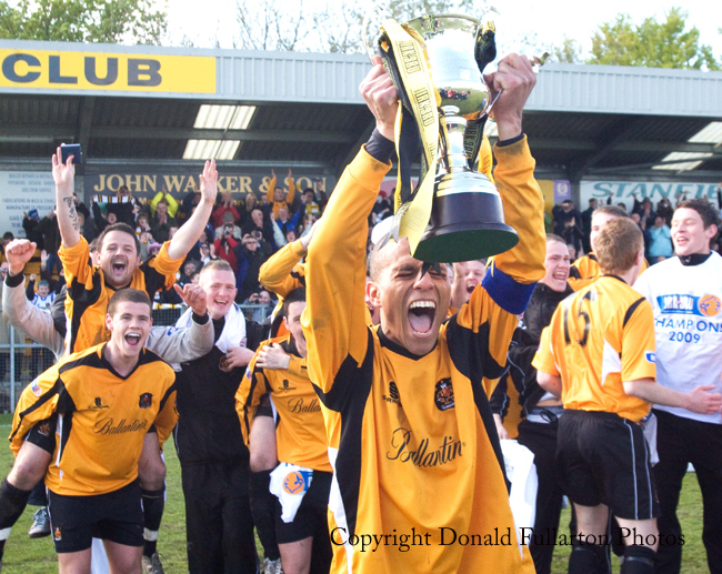 Captain Gordon Lennon holds aloft the third division trophy.