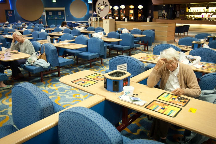 Women concentrate on their bingo cards as the numbers are called at Gala Bingo Feltham, west London