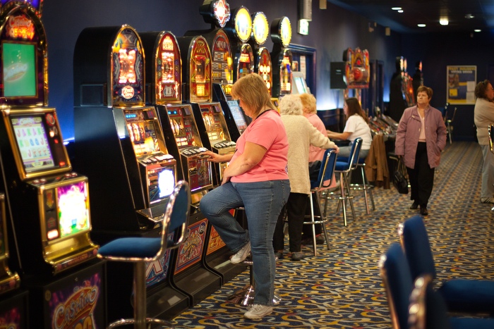 A woman gambles on a fruit machine after leaving the bingo hall