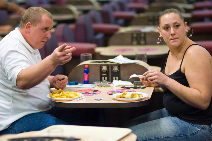 A couple enjoy a meal of chips and curry sauce during a game at Mecca Bingo in Wandsworth, south London