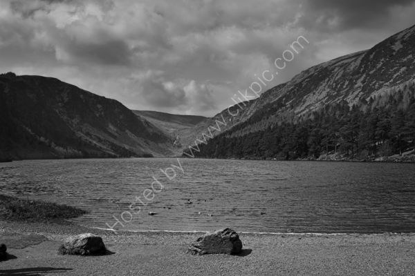 A black and white image of the upper lake at Glendalough
