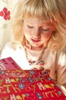 young girl opening present