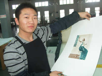 Liu Hong Liang proudly displays a print