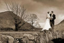 Adam and Jo on the bridge behind their home at Wasdale Head