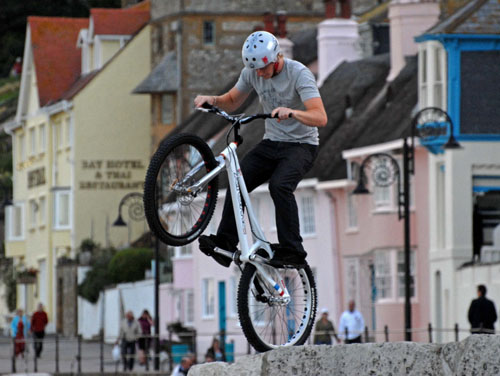 Balancing young biker, Lyme Regis sea front