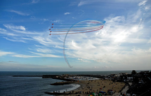 The Red Arrows looping over Lyme Regis harbour and the Cobb
