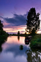 A Narrowboat on the Great Ouse at dusk